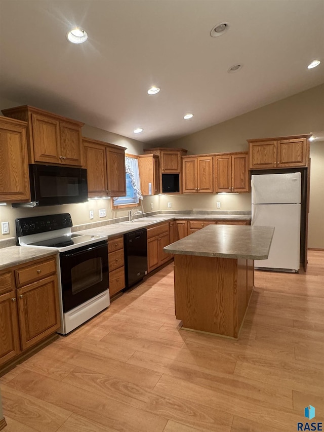300 W Pipestone Ave, Flandreau, SD 57028 - kitchen featuring black appliances, light wood-style floors, a kitchen island, recessed lighting, and brown cabinets