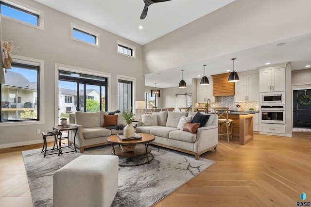 212 Autumnwood Ct, Sioux Falls, SD 57110 - living area featuring ceiling fan, a towering ceiling, recessed lighting, and baseboards