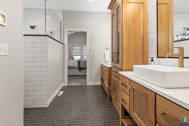 212 Autumnwood Ct, Sioux Falls, SD 57110 - full bath with ensuite bathroom, vanity, and a tile shower