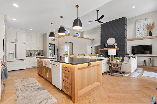 212 Autumnwood Ct, Sioux Falls, SD 57110 - kitchen with white appliances, dark countertops, recessed lighting, ceiling fan, and a sink