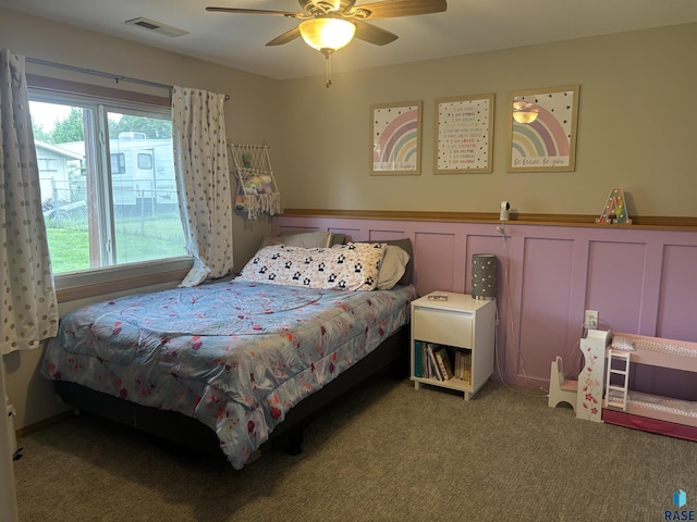 8000 W 44th St, Sioux Falls, SD 57106 - bedroom featuring carpet, a ceiling fan, and a wainscoted wall