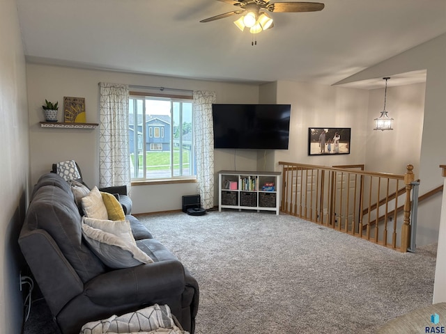 8000 W 44th St, Sioux Falls, SD 57106 - carpeted living room featuring a ceiling fan, vaulted ceiling, and baseboards