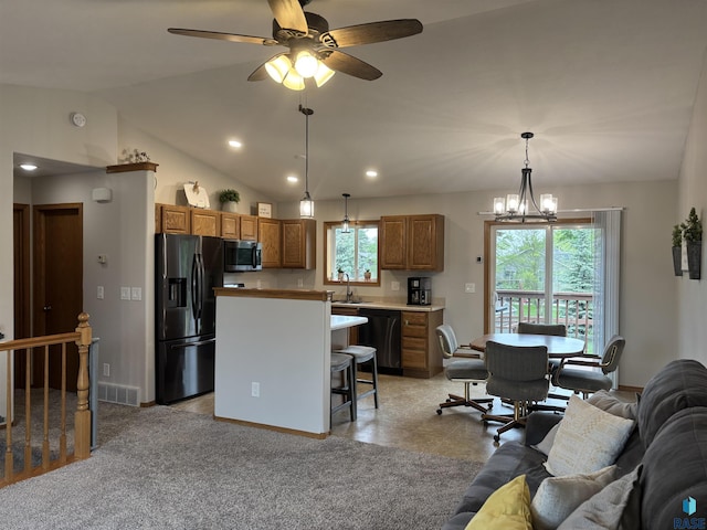 8000 W 44th St, Sioux Falls, SD 57106 - kitchen with black appliances, a sink, open floor plan, a ceiling fan, and brown cabinets
