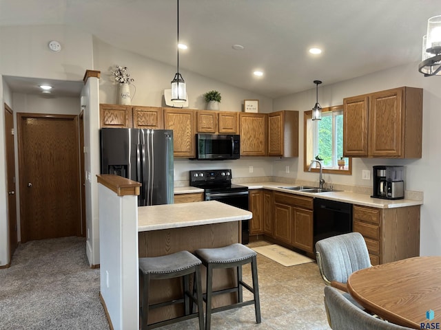 8000 W 44th St, Sioux Falls, SD 57106 - kitchen featuring black appliances, a sink, vaulted ceiling, hanging light fixtures, and light countertops