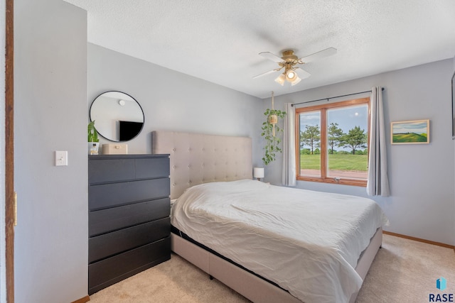 4201 E 22nd St, Sioux Falls, SD 57103 - carpeted bedroom with a textured ceiling, baseboards, and ceiling fan