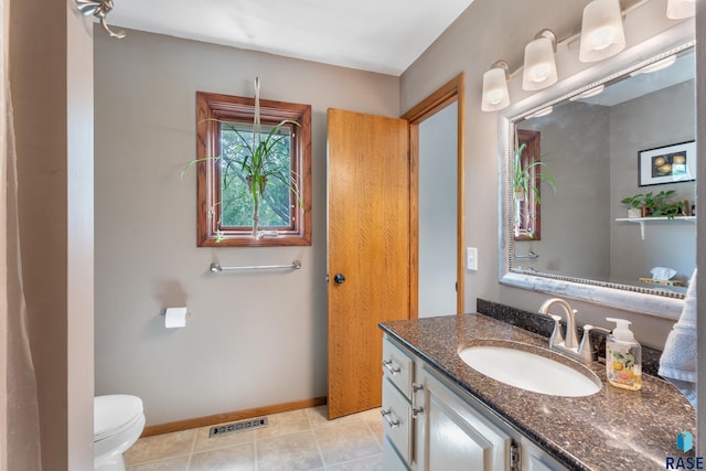 4201 E 22nd St, Sioux Falls, SD 57103 - bathroom with vanity, toilet, tile patterned flooring, and baseboards