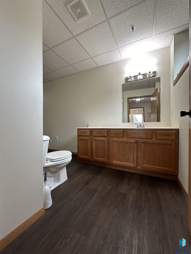109 E Luverne St Unit 220, Luverne, MN 56156 - bathroom with toilet, wood finished floors, a paneled ceiling, baseboards, and vanity