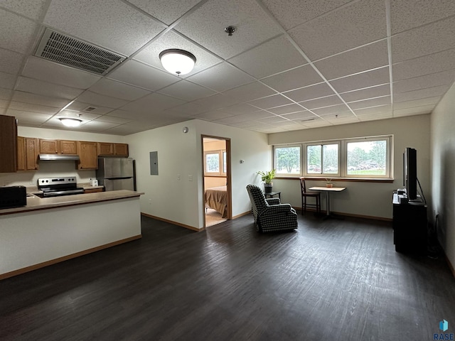 109 E Luverne St Unit 220, Luverne, MN 56156 - kitchen featuring appliances with stainless steel finishes, dark wood-style floors, a drop ceiling, brown cabinets, and under cabinet range hood