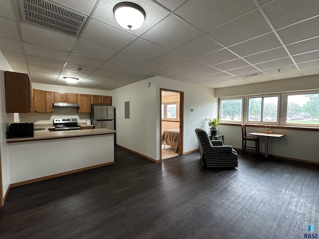 109 E Luverne St Unit 220, Luverne, MN 56156 - kitchen featuring appliances with stainless steel finishes, a paneled ceiling, dark wood-style floors, brown cabinets, and under cabinet range hood