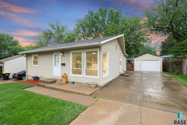 904 S Marday Ave, Sioux Falls, SD 57103 - view of front of home featuring a garage, an outbuilding, and a shingled roof