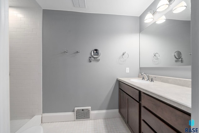 809 S Duluth Ave, Sioux Falls, SD 57104 - bathroom with vanity, tile patterned flooring, baseboards, and tiled shower