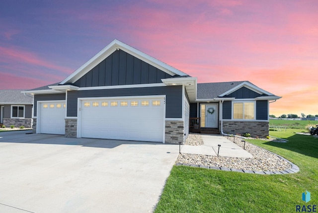 622 Creekside Trl, Harrisburg, SD 57032 - view of front of property featuring stone siding, a garage, board and batten siding, and concrete driveway