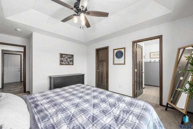 622 Creekside Trl, Harrisburg, SD 57032 - bedroom with a tray ceiling, carpet, and ceiling fan