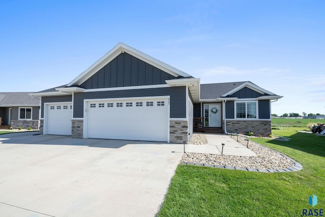 622 Creekside Trl, Harrisburg, SD 57032 - view of front of property featuring stone siding, an attached garage, and a front lawn