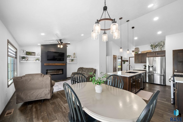 622 Creekside Trl, Harrisburg, SD 57032 - dining space featuring lofted ceiling, a ceiling fan, a fireplace, dark wood finished floors, and recessed lighting