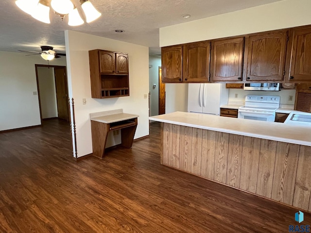 502 E 4th St, Canton, SD 57013 - kitchen with white appliances, light countertops, dark wood-style flooring, a peninsula, and a textured ceiling