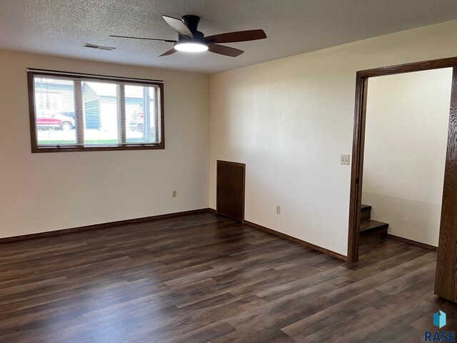 502 E 4th St, Canton, SD 57013 - empty room with ceiling fan, dark wood-style flooring, baseboards, and a textured ceiling