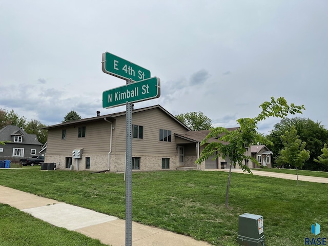 502 E 4th St, Canton, SD 57013 - view of front facade with a front yard, central air condition unit, brick siding, and concrete driveway