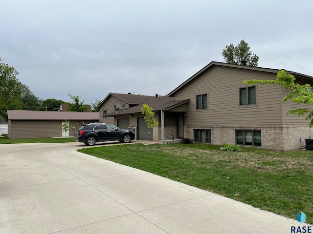 502 E 4th St, Canton, SD 57013 - tri-level home with concrete driveway, an attached garage, a front lawn, brick siding, and cooling unit