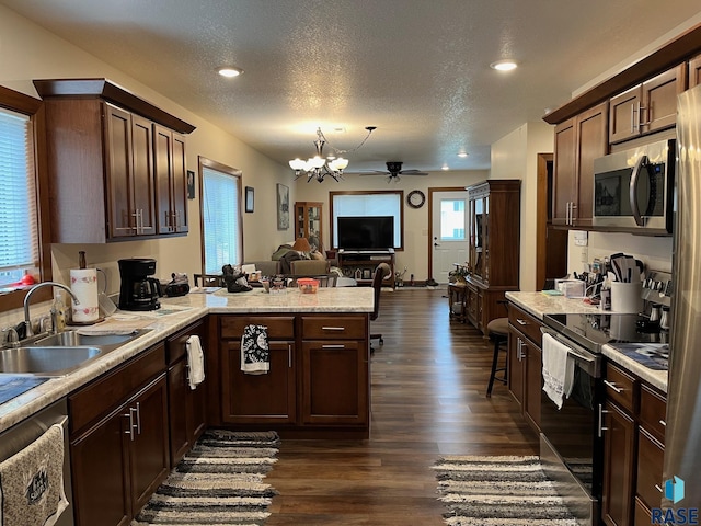 502 E 4th St, Canton, SD 57013 - kitchen with appliances with stainless steel finishes, dark wood-type flooring, open floor plan, a sink, and light countertops