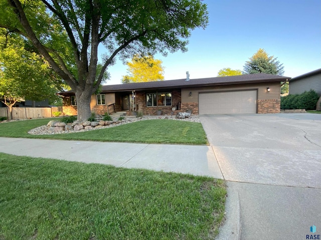 4604 S Woodwind Ln, Sioux Falls, SD 57103 - single story home with a garage, concrete driveway, and brick siding
