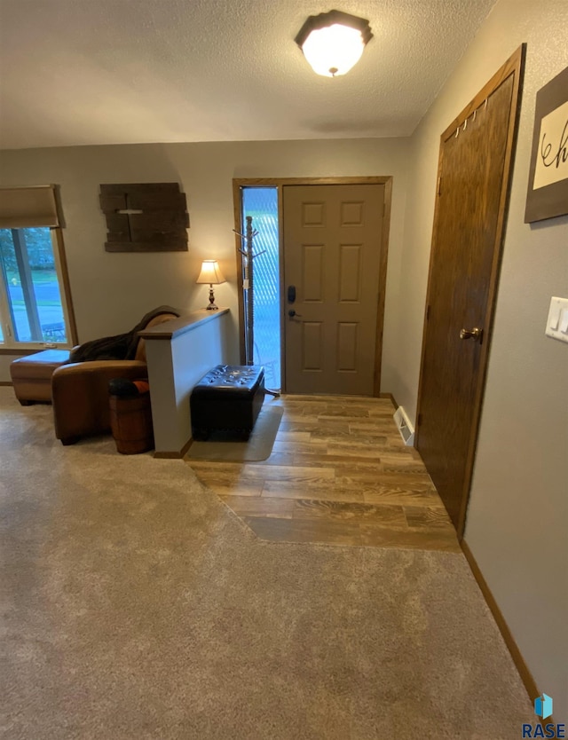 4604 S Woodwind Ln, Sioux Falls, SD 57103 - carpeted foyer entrance with a textured ceiling and baseboards