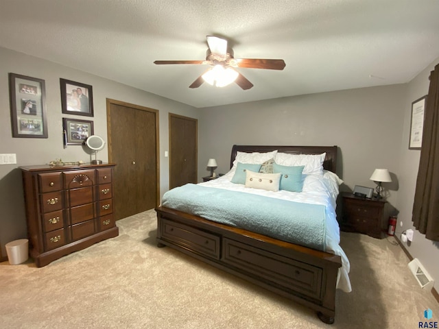 4604 S Woodwind Ln, Sioux Falls, SD 57103 - bedroom with light colored carpet, multiple closets, and ceiling fan