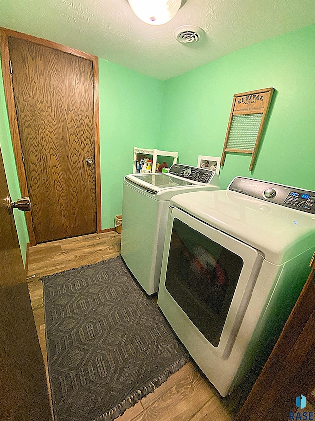 4604 S Woodwind Ln, Sioux Falls, SD 57103 - washroom with washing machine and clothes dryer and wood finished floors