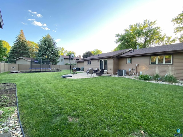 4604 S Woodwind Ln, Sioux Falls, SD 57103 - view of yard with a trampoline, a patio, and central AC unit