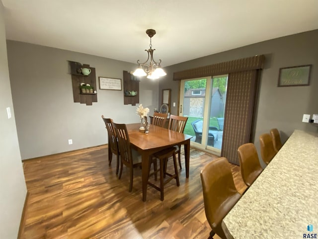4604 S Woodwind Ln, Sioux Falls, SD 57103 - dining space featuring dark wood-type flooring, a chandelier, and baseboards