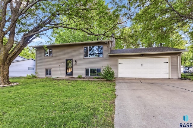6501 W 46th St, Sioux Falls, SD 57106 - view of front of property with concrete driveway, a front lawn, a garage, and a chimney