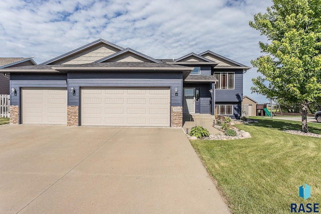 5205 S Culbert Ave, Sioux Falls, SD 57106 - tri-level home featuring an attached garage, driveway, a front yard, and a playground