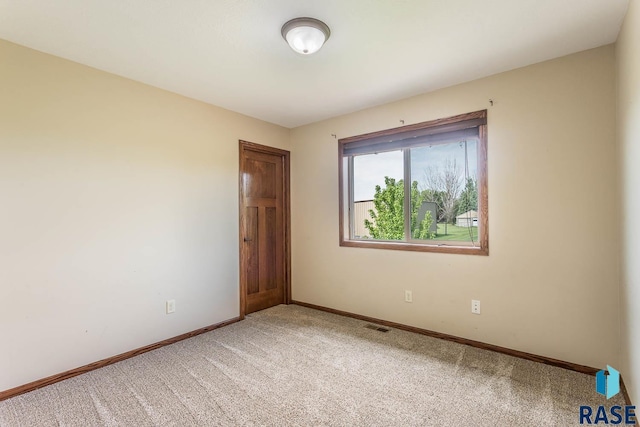 5205 S Culbert Ave, Sioux Falls, SD 57106 - spare room with baseboards and light colored carpet