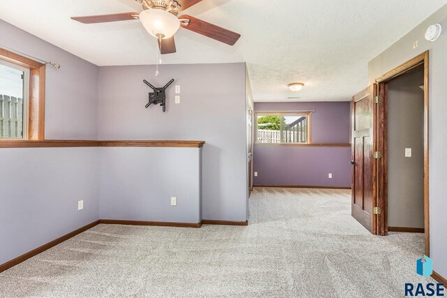 5205 S Culbert Ave, Sioux Falls, SD 57106 - empty room featuring carpet flooring, ceiling fan, baseboards, and a smoke detector