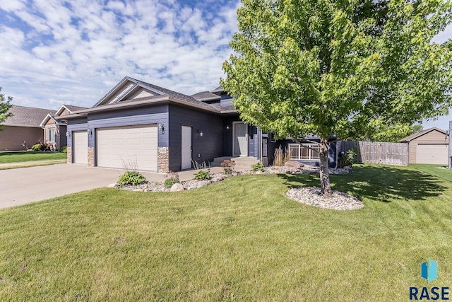 5205 S Culbert Ave, Sioux Falls, SD 57106 - view of front of home with an attached garage, driveway, and stone siding