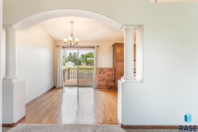 5205 S Culbert Ave, Sioux Falls, SD 57106 - dining area with light wood-style floors, arched walkways, baseboards, and a chandelier