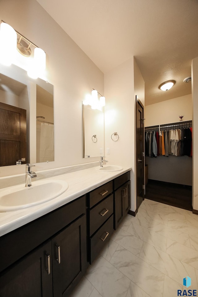 2407 E Copalis Pl, Sioux Falls, SD 57108 - full bath featuring double vanity, a spacious closet, and marble finish floors