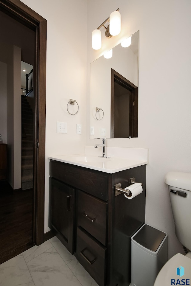 2407 E Copalis Pl, Sioux Falls, SD 57108 - half bathroom with vanity, toilet, and marble look tile flooring