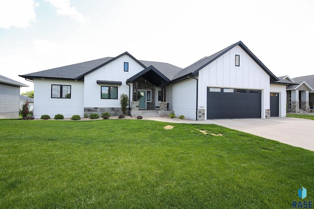 8609 E Fiddlewood Dr, Sioux Falls, SD 57110 - modern farmhouse with board and batten siding, an attached garage, stone siding, concrete driveway, and a front yard