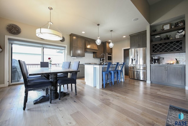 8609 E Fiddlewood Dr, Sioux Falls, SD 57110 - dining space with light wood-style flooring and recessed lighting