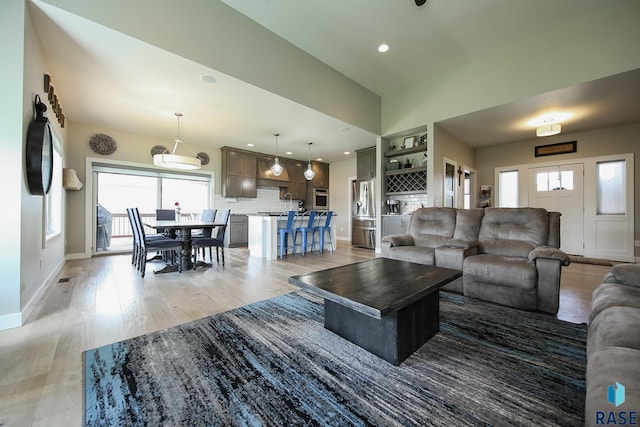 8609 E Fiddlewood Dr, Sioux Falls, SD 57110 - living area with healthy amount of natural light, light wood finished floors, and recessed lighting