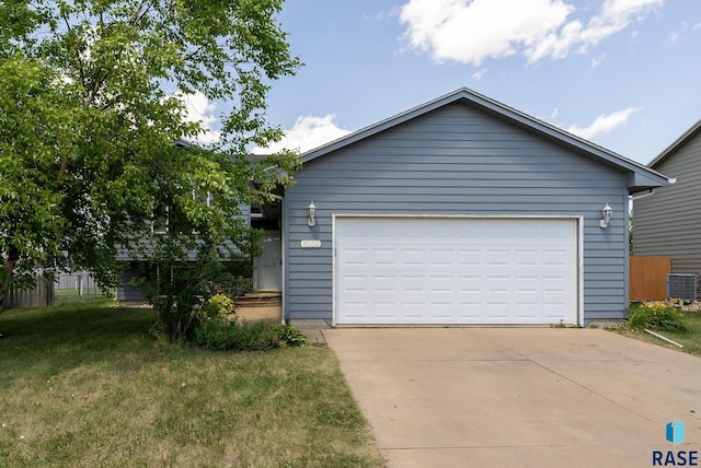 7104 W 68th St, Sioux Falls, SD 57106 - view of front facade with central AC unit, a front lawn, and a detached garage