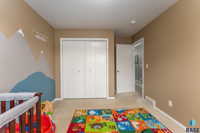 7104 W 68th St, Sioux Falls, SD 57106 - carpeted bedroom with a closet, a textured ceiling, and baseboards