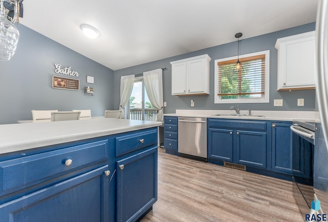 7104 W 68th St, Sioux Falls, SD 57106 - kitchen with stainless steel appliances, blue cabinetry, a sink, white cabinets, and lofted ceiling