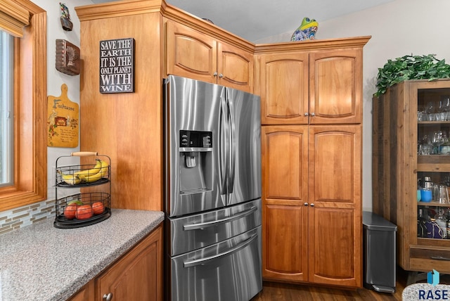 46493 258th St, Hartford, SD 57033 - kitchen featuring stainless steel refrigerator with ice dispenser, backsplash, brown cabinets, and dark wood finished floors