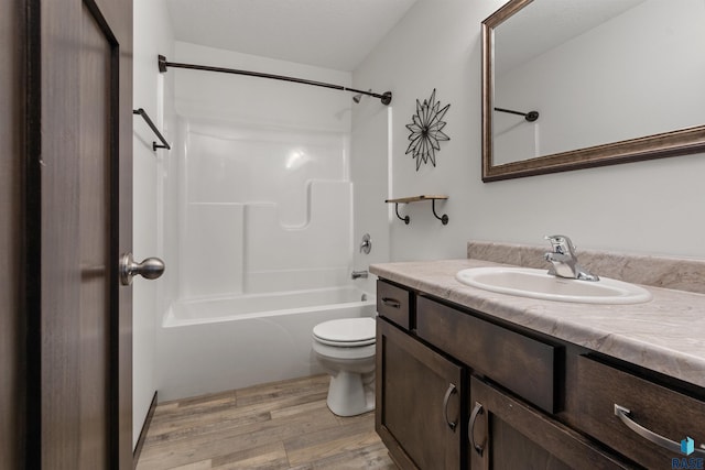 9509 W Liam St, Sioux Falls, SD 57106 - bathroom with vanity, toilet, washtub / shower combination, and wood finished floors
