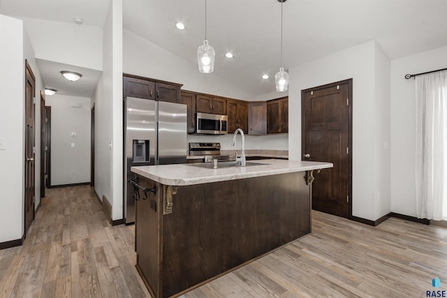 9509 W Liam St, Sioux Falls, SD 57106 - kitchen featuring appliances with stainless steel finishes, a sink, dark brown cabinets, light countertops, and light wood finished floors