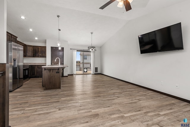 9509 W Liam St, Sioux Falls, SD 57106 - kitchen featuring appliances with stainless steel finishes, vaulted ceiling, a ceiling fan, dark brown cabinets, and open floor plan