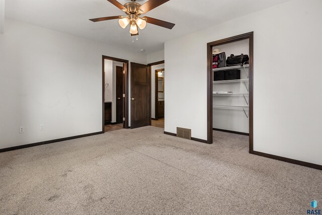 9509 W Liam St, Sioux Falls, SD 57106 - unfurnished bedroom with carpet floors, a walk in closet, baseboards, and a closet
