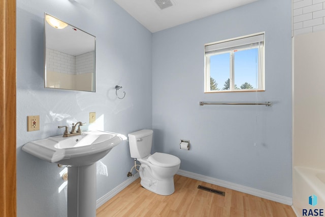 25280 480th Ave, Garretson, SD 57030 - full bath with wood finished floors, toilet, a bathtub, baseboards, and a shower